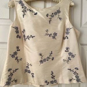 Blouse, sleeveless, 100% silk with embroidered blue flowers.